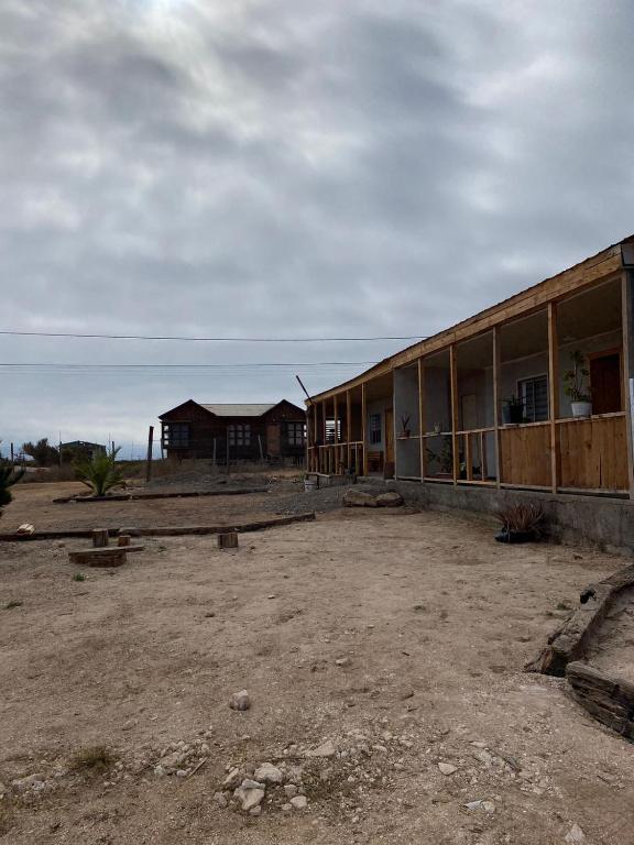 a building in the middle of a dirt field at Cabañas CR guanaqueros in Coquimbo
