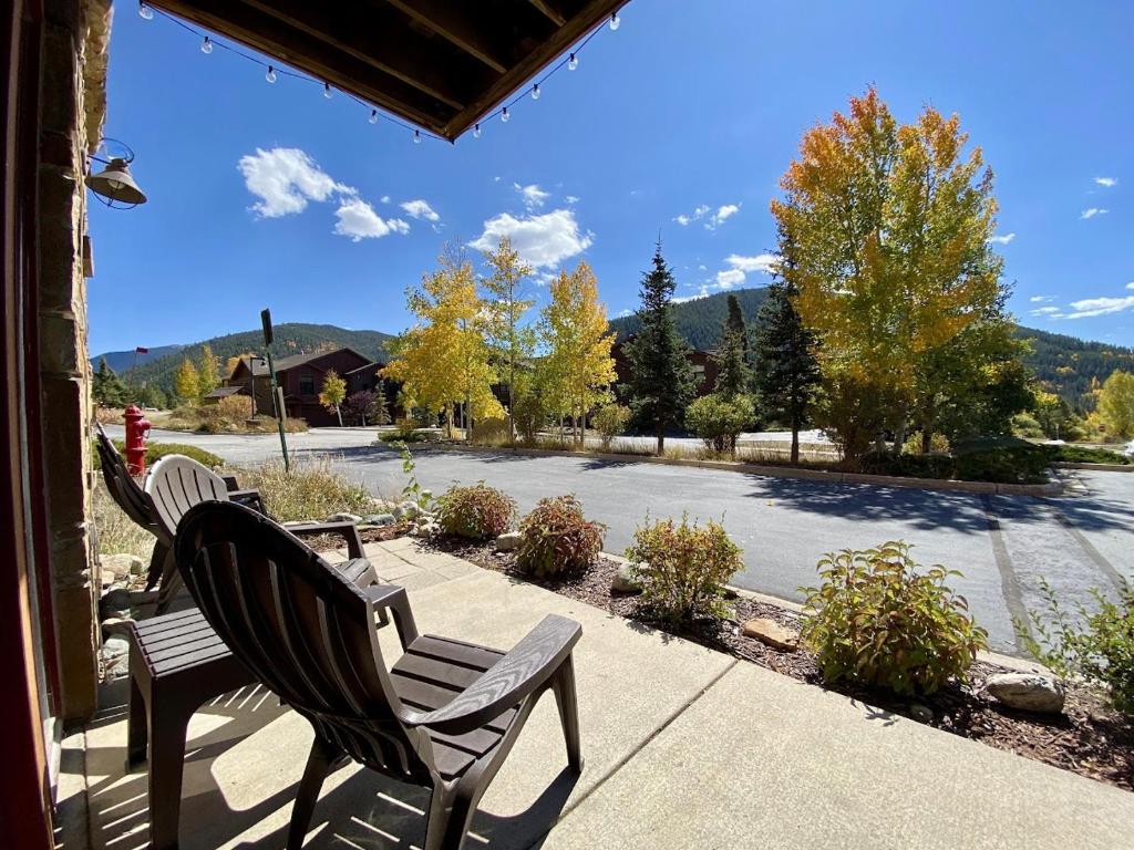 two chairs on a porch with a view of a street at Antlers Gulch 106 by SummitCove Lodging in Colorado in Keystone