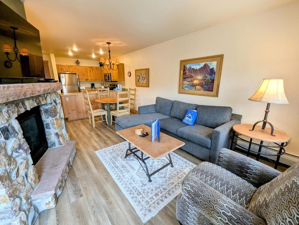 a living room with a couch and a fireplace at Expedition Station 8622 by SummitCove Lodging in Colorado in Keystone