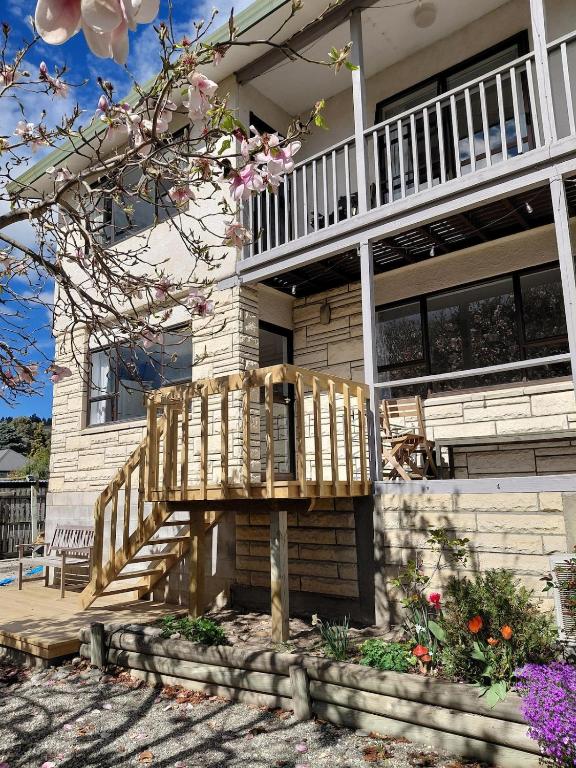 a house with a wooden deck in front of it at Private Flat in Bridge Hill in Alexandra