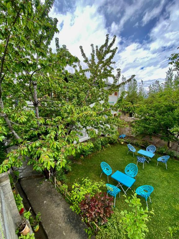 a group of chairs and tables in a yard at Creek Villa Skardu in Skardu