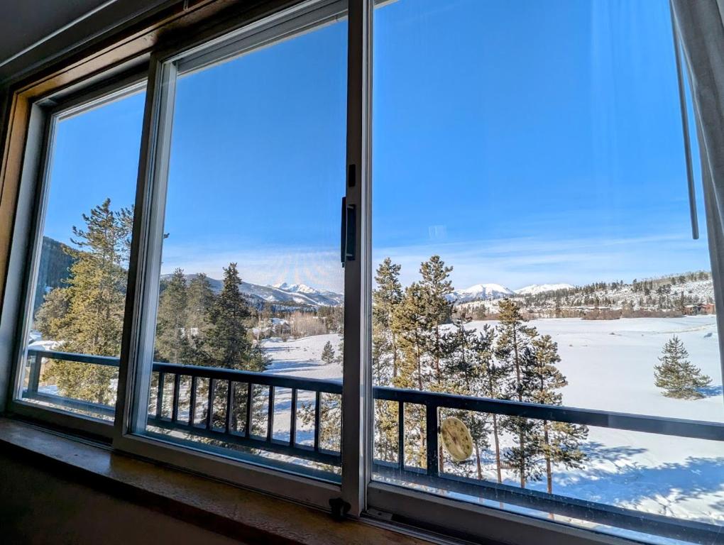 a window with a view of a snow covered field at Pines 2129 by SummitCove Lodging in Colorado in Keystone