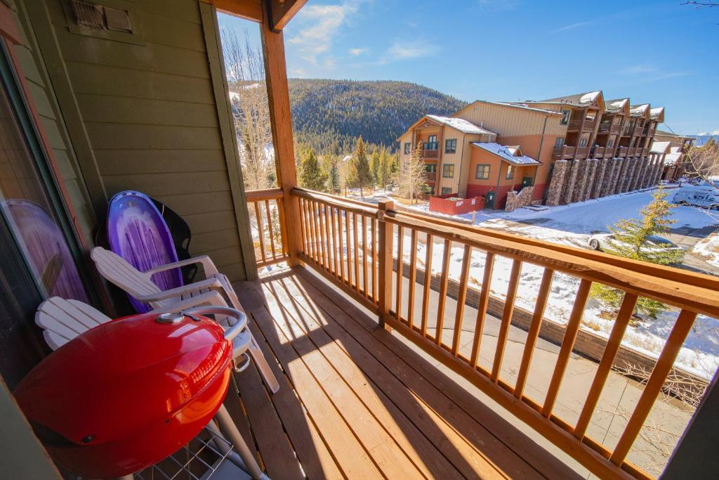 a balcony with a rocking chair and a view of a mountain at Tenderfoot Lodge 2620 by SummitCove Lodging in Colorado in Keystone
