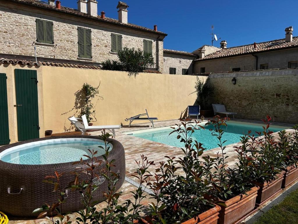 a backyard with a swimming pool and a house at Apartment Monsignore, Pesaro in Pesaro