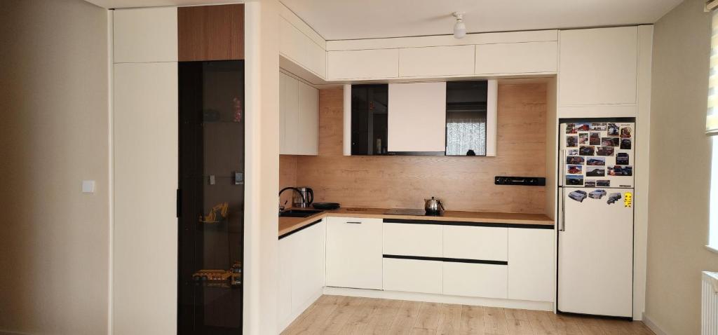 a kitchen with white cabinets and a refrigerator at "Private Room in New Luxury " Apartment in Ulaanbaatar