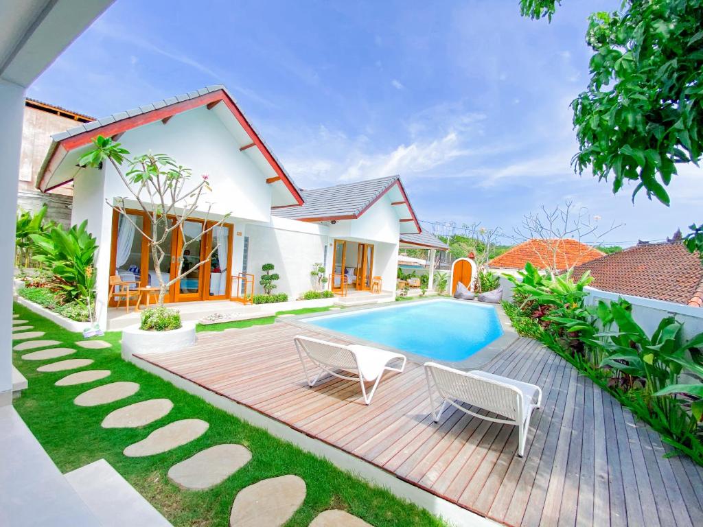 a villa with a swimming pool and a house at Casa de Ambalia in Uluwatu