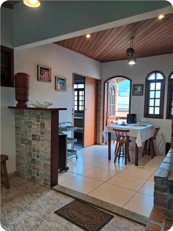 a living room with a table and a fireplace at Canto dos pássaros in Volta Redonda