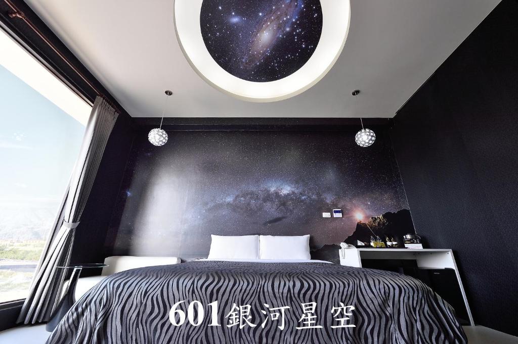 a bedroom with a large bed and a window at CoCo Motel Boutique in Puli