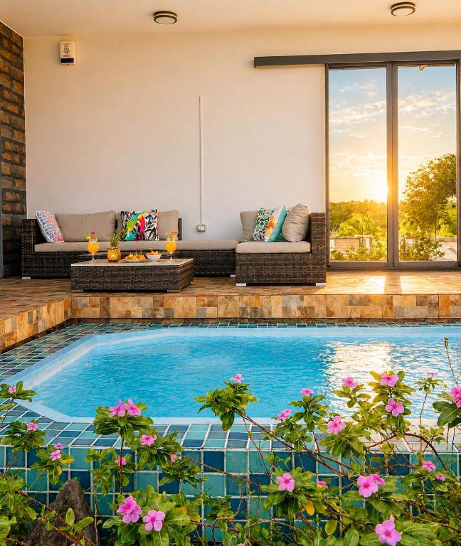 a swimming pool in a house with a patio at Lakeview Bellemare Villa in Belle Mare