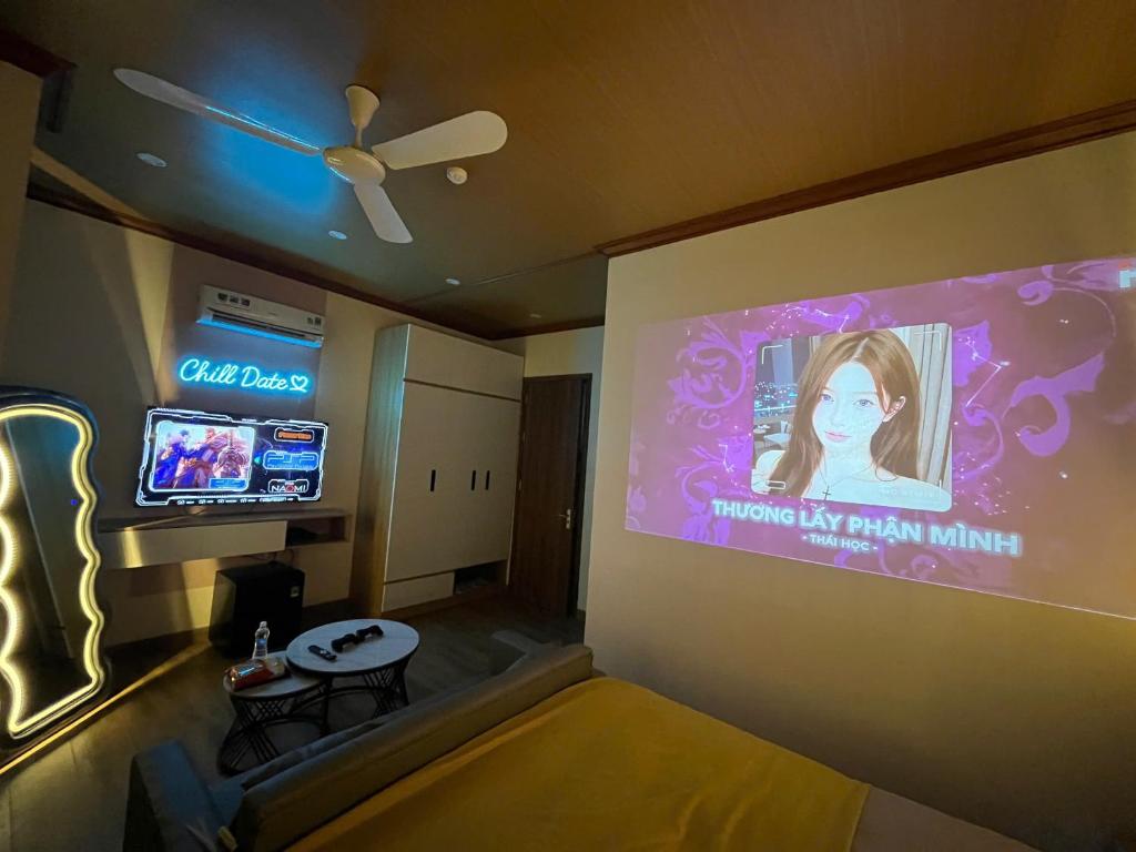 a room with a large projection screen and a table at ChillDate in Bắc Ninh