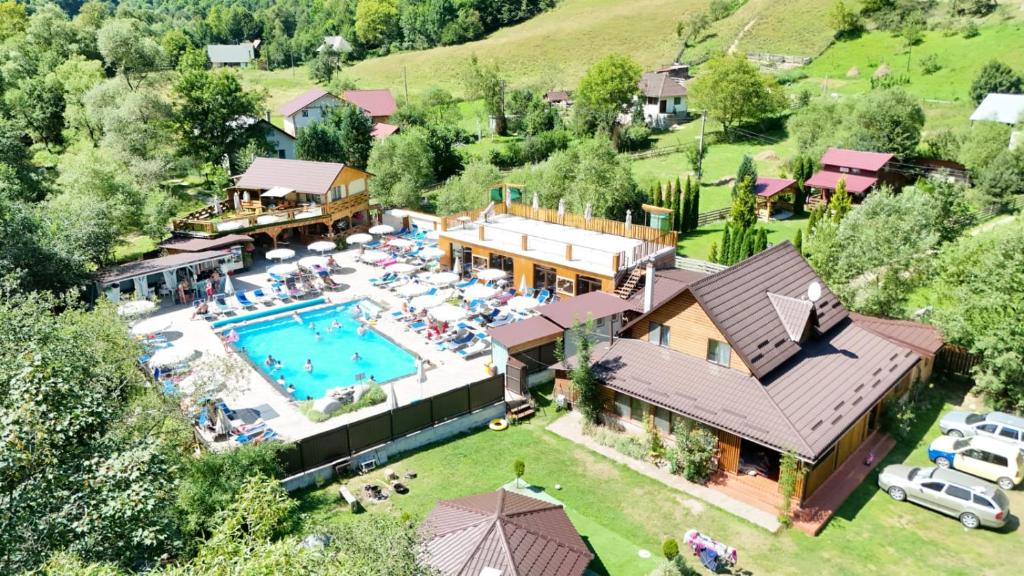 an aerial view of a house with a swimming pool at Cabana Denny in Mărişel