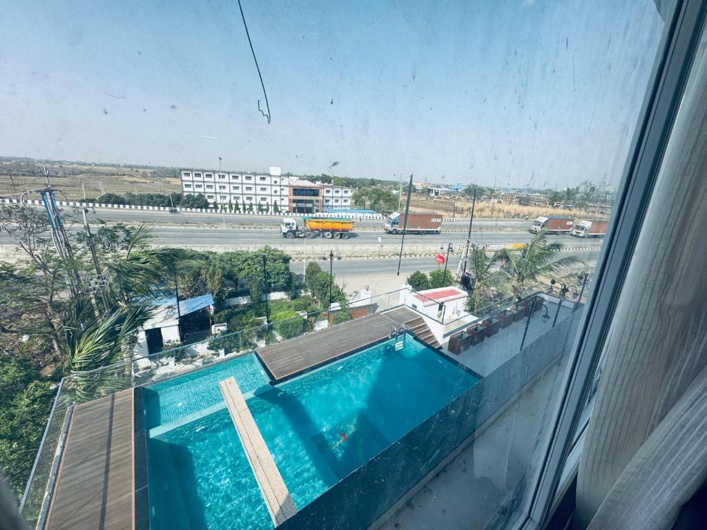 a view of a swimming pool from a window at Hotel Vaishnavi Heights in Aurangābād