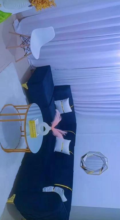 a room with a bed with blue sheets and pillows at Homes by lucy in Mombasa