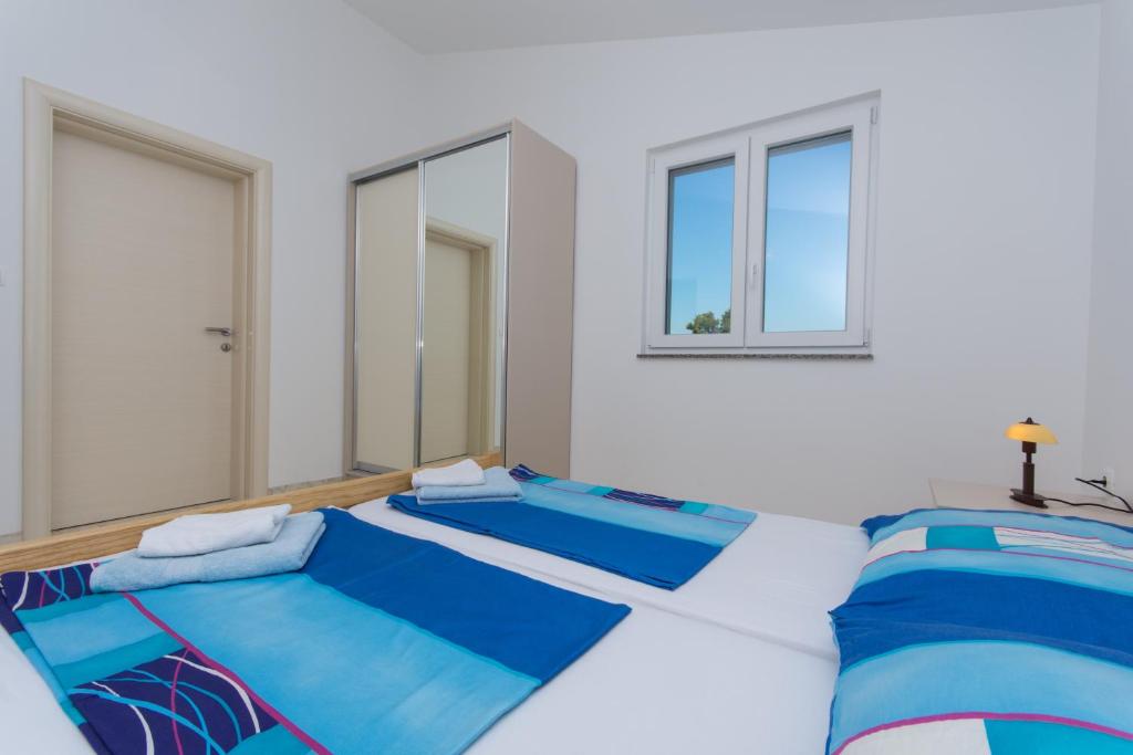 Posteľ alebo postele v izbe v ubytovaní Apartments Jaman Ivan