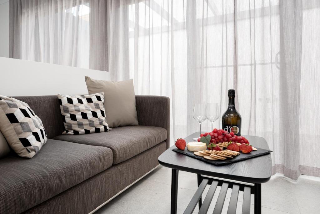 a living room with a couch and a table with a plate of food at Marine Cove in Yarrawonga
