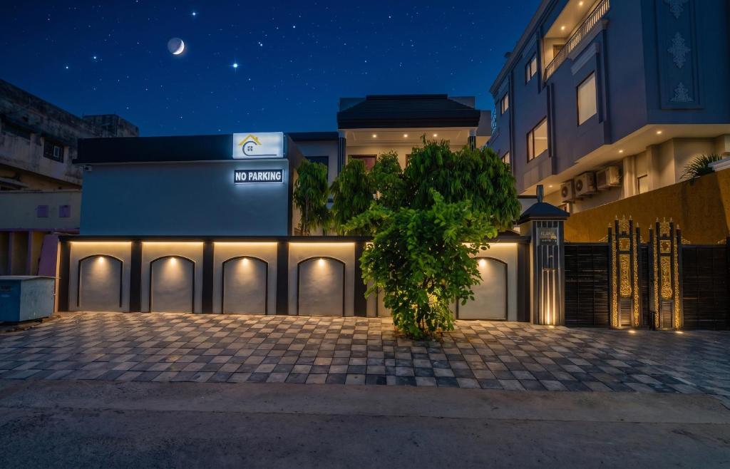 a tree in front of a building at night at The Amber House - Luxury Boutique Stay in Bani Park, City Center Jaipur in Jaipur