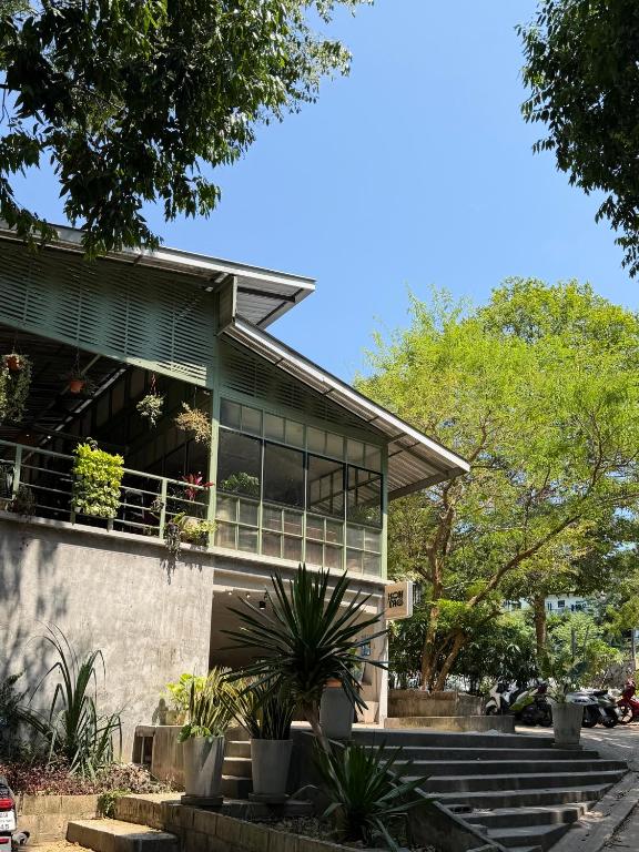 a house with large windows and plants in front of it at Koh Tao Stay in Ko Tao