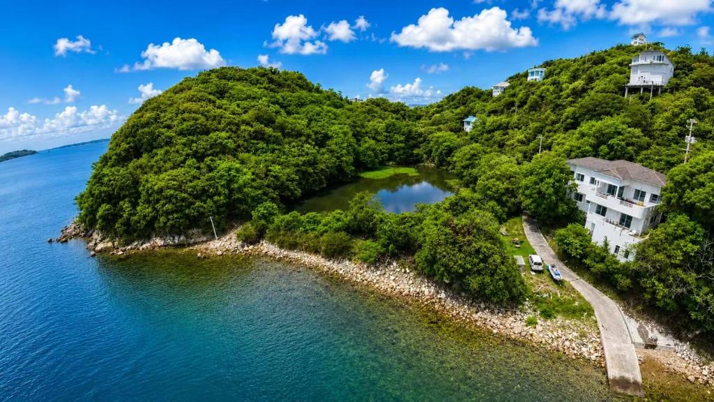 an island in the water with a building on it at Large Beachfront Island Villa Sleeps 12 Ideal for Groups in Bizen