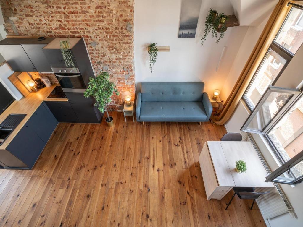 an overhead view of a living room with a blue couch at Two-bedroom apartment by the river in Antwerp