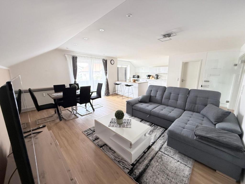 a living room with a couch and a table at Toukam's Apartment, near Ingolstadt in Stammham