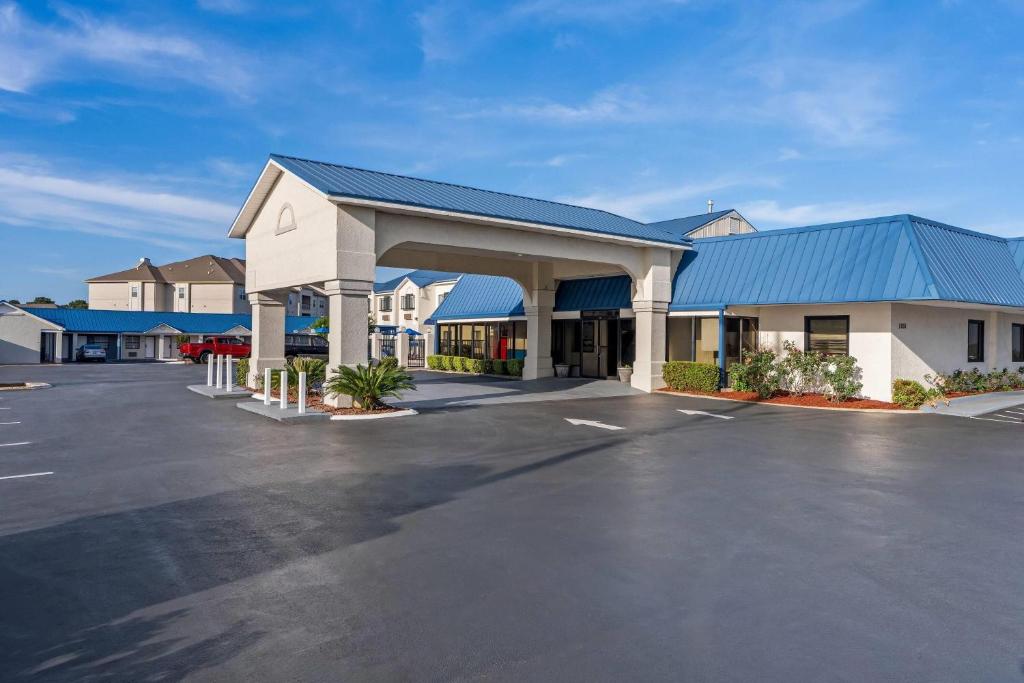 a parking lot in front of a hotel at Days Inn by Wyndham Troy in Troy
