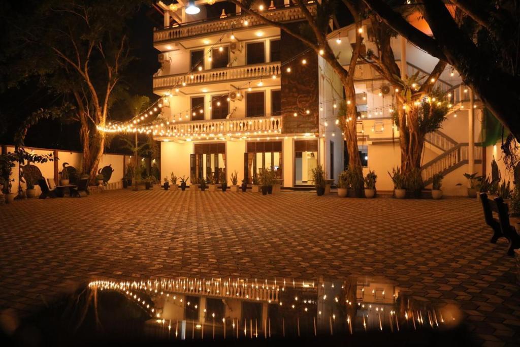 a building with christmas lights in front of it at Polhena Neptune Resort in Matara
