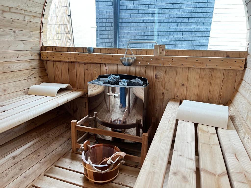 a sauna with a table and a bench and a sink at vacation house N in Nago