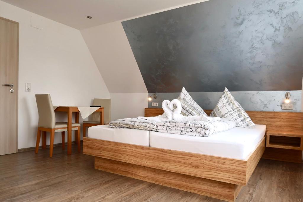 a bedroom with a bed with white towels on it at Pension Seehund in Norddeich in Norden