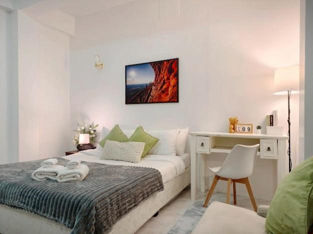 a bedroom with a bed with a desk and a desk at Xin Hotel at Udomsuk 25 in Bangna