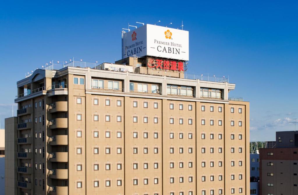 a building with a sign on top of it at Premier Hotel -CABIN- Asahikawa in Asahikawa