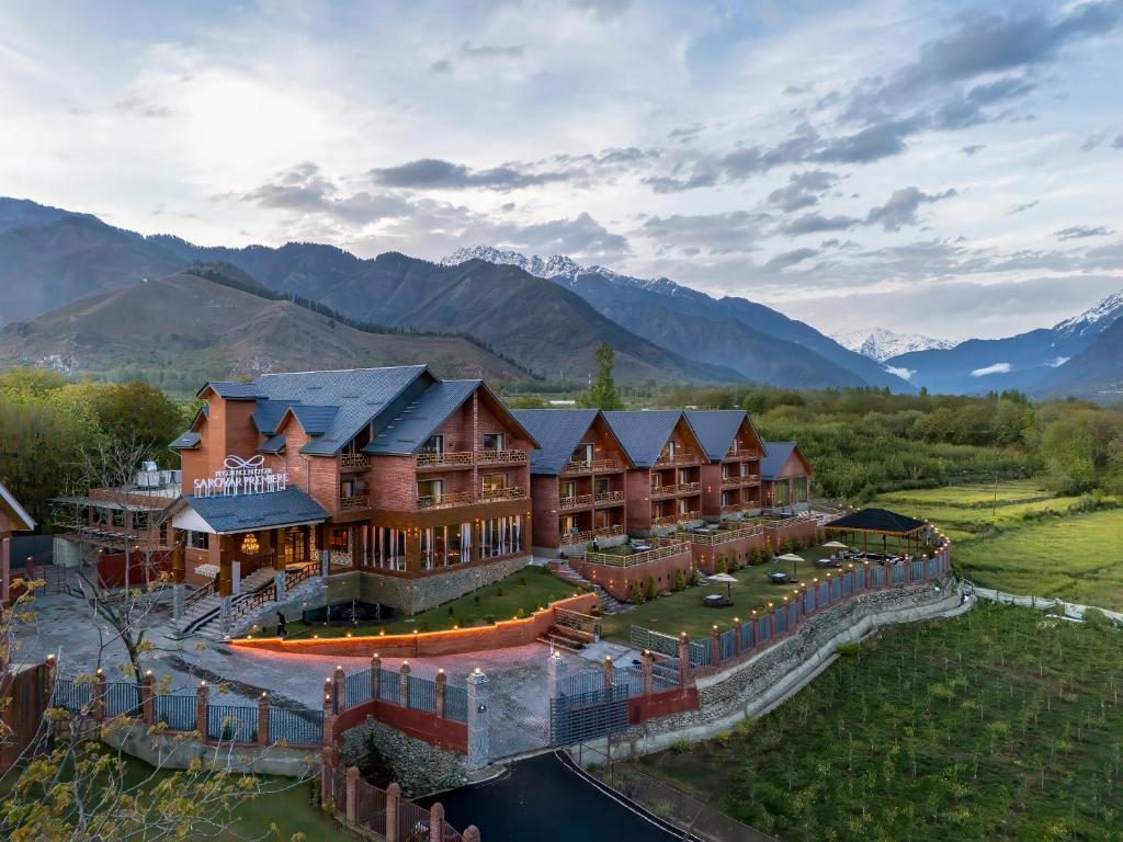 an aerial view of a resort with mountains in the background at Mountnoor Sarovar Premiere Pahalgam in Anantnāg
