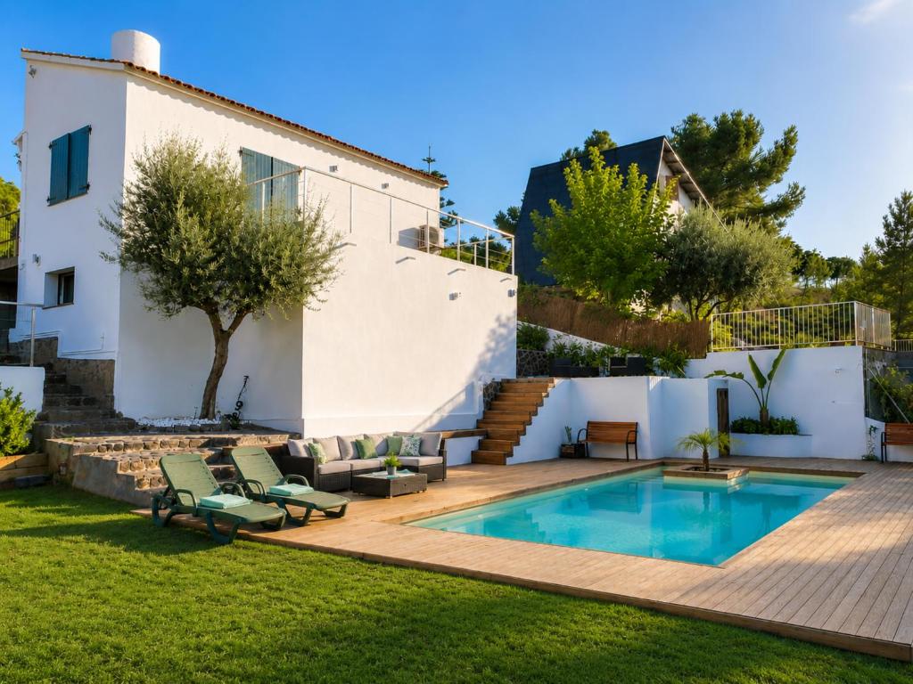 a backyard with a swimming pool and a house at VILLA PARADISE SILVIA in Sant Pere de Ribes