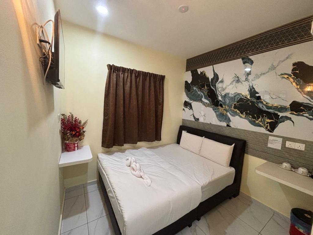 a small bed in a small room with at Collection O Near Sunway Karnival Mall Formerly Rest Haven in Bukit Mertajam