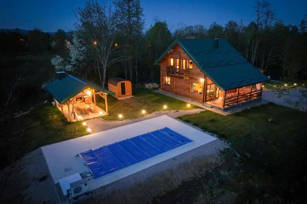 a house with a swimming pool in the yard at night at Lika View house in Gospić
