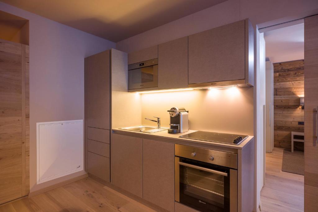 a kitchen with a sink and a stove at Postresidenz in Mayrhofen