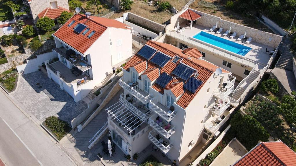 an aerial view of a white house with a swimming pool at Villa Samba in Mlini