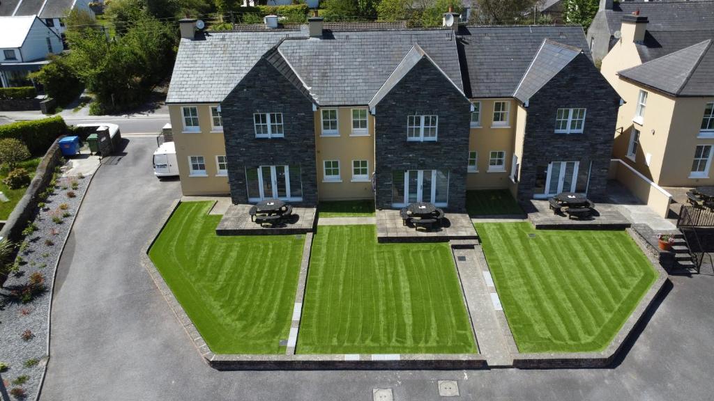 an aerial view of a house with a green lawn at Number 1 Bank House in Schull