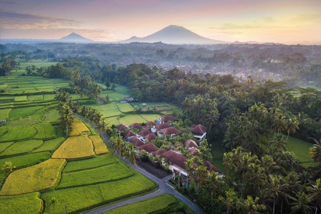 an aerial view of a resort with mountains in the background at Dedary Resort & Spa Ubud by Ini Vie Hospitality in Ubud