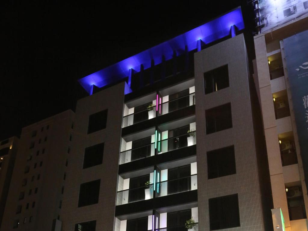 a building with blue lights on top of it at Miller Inn in Taichung