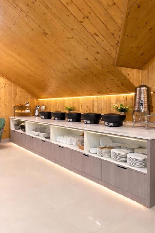 a kitchen with a counter with pots and pans at Hotel Belvior Estate in Srinagar