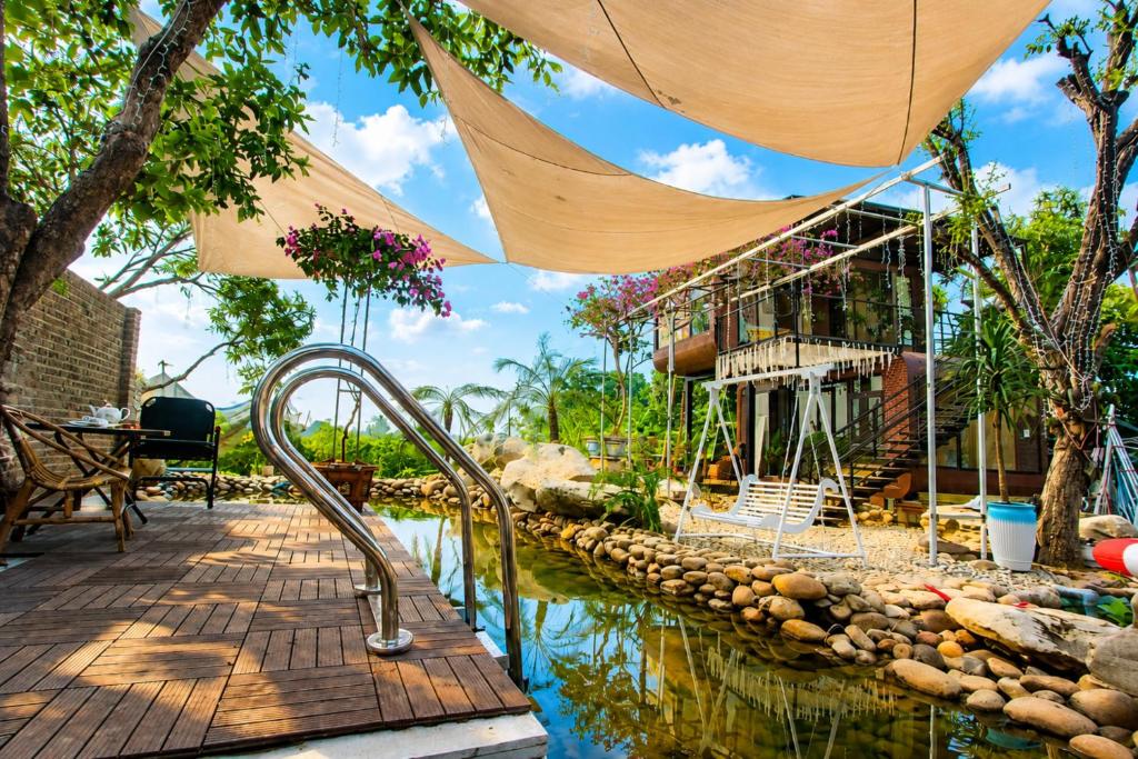 a pool of water in front of a house at Tình's Homestay in Ninh Binh