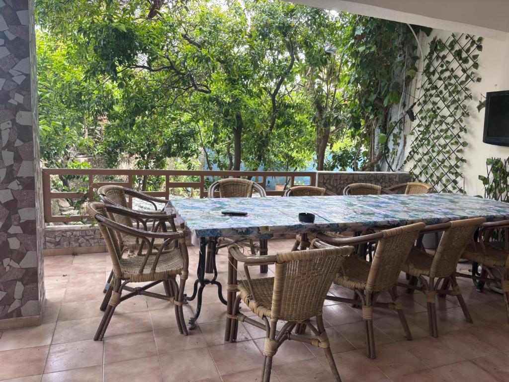 a table and chairs on a patio with trees at Aleka Apartments in Kos