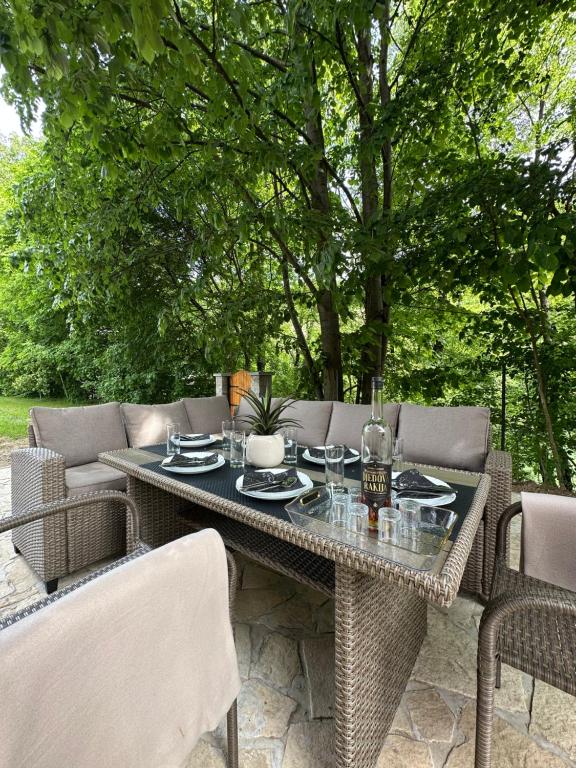 a table and chairs sitting on a patio at Green District - Riverside Luxury Lodge in Banja Luka