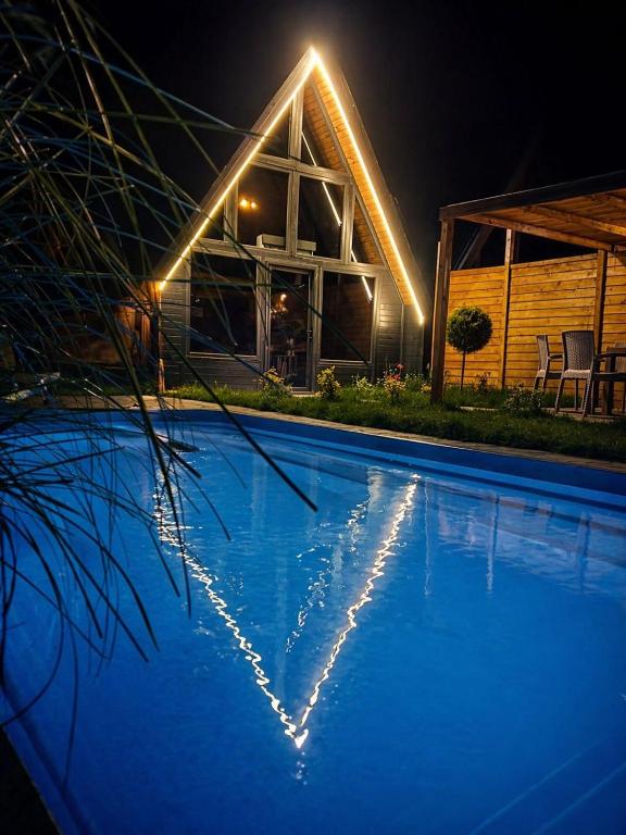 a swimming pool in front of a house at night at Deniz Bungalov samsun in Samsun
