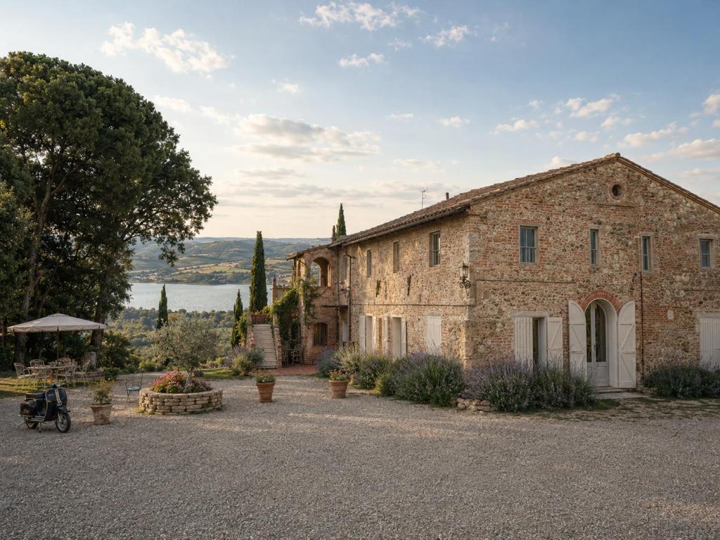 an old stone house with a large yard at Terracqua Retreat I Essence of Tuscany in Chiusi