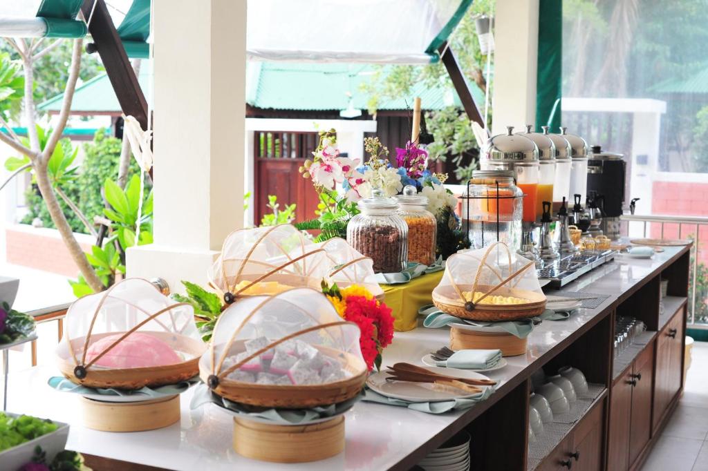 a buffet of food on a table with dishes at Lamai Coconut Beach Resort in Lamai