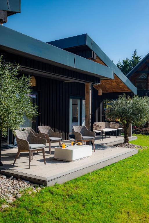 a group of chairs on a patio in front of a building at Retreat 10 in Beccles