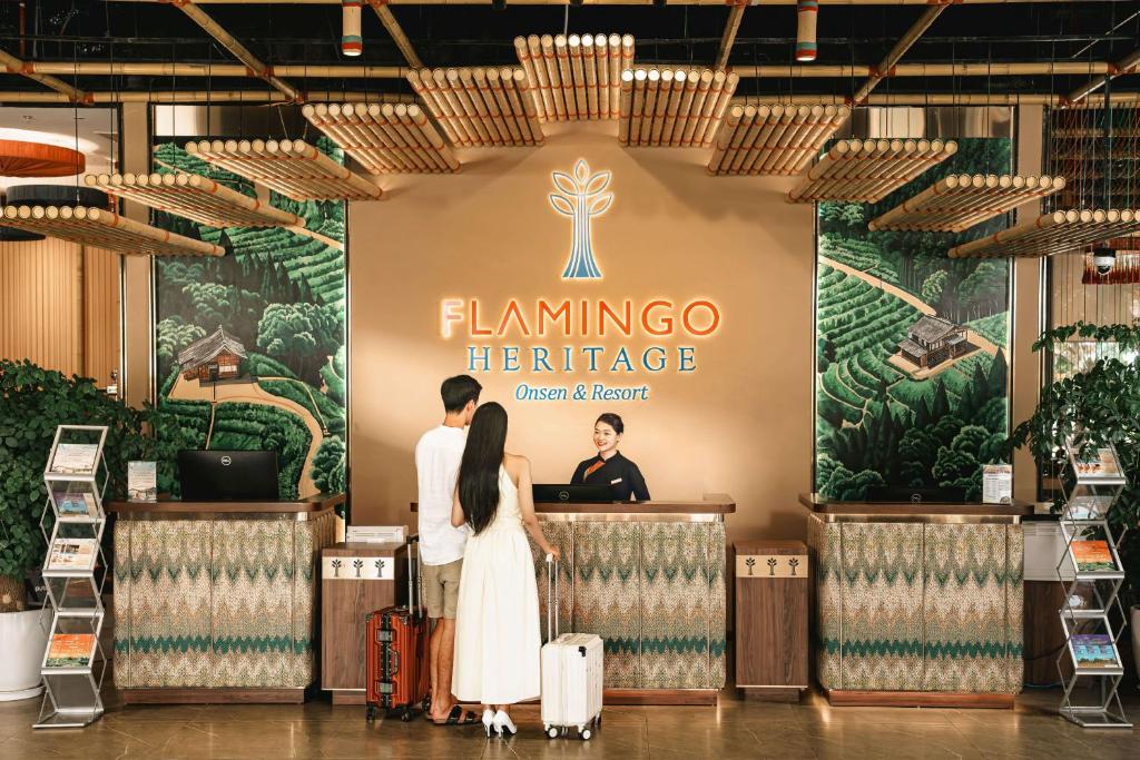 a couple standing in front of a stage at an event at Flamingo Tan Trao Resort Managed by Flamingo Hotels & Resorts in Sơn Dương