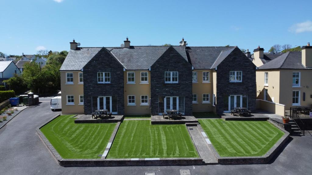 a large house with a green lawn in front of it at Number 2 Bank House in Schull
