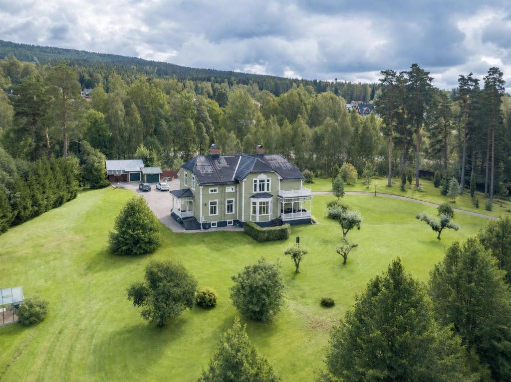 an aerial view of a large house on a grass field at SwedenWoods in Hagfors